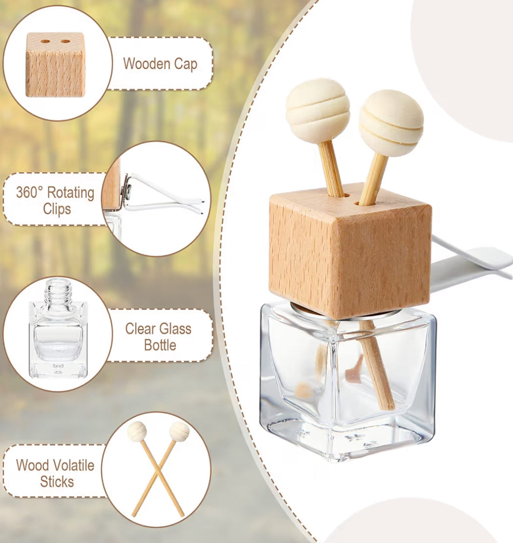 A clear glass diffuser bottle with wooden cap andvolatile sticks, featuring close-up details on a neutral background.