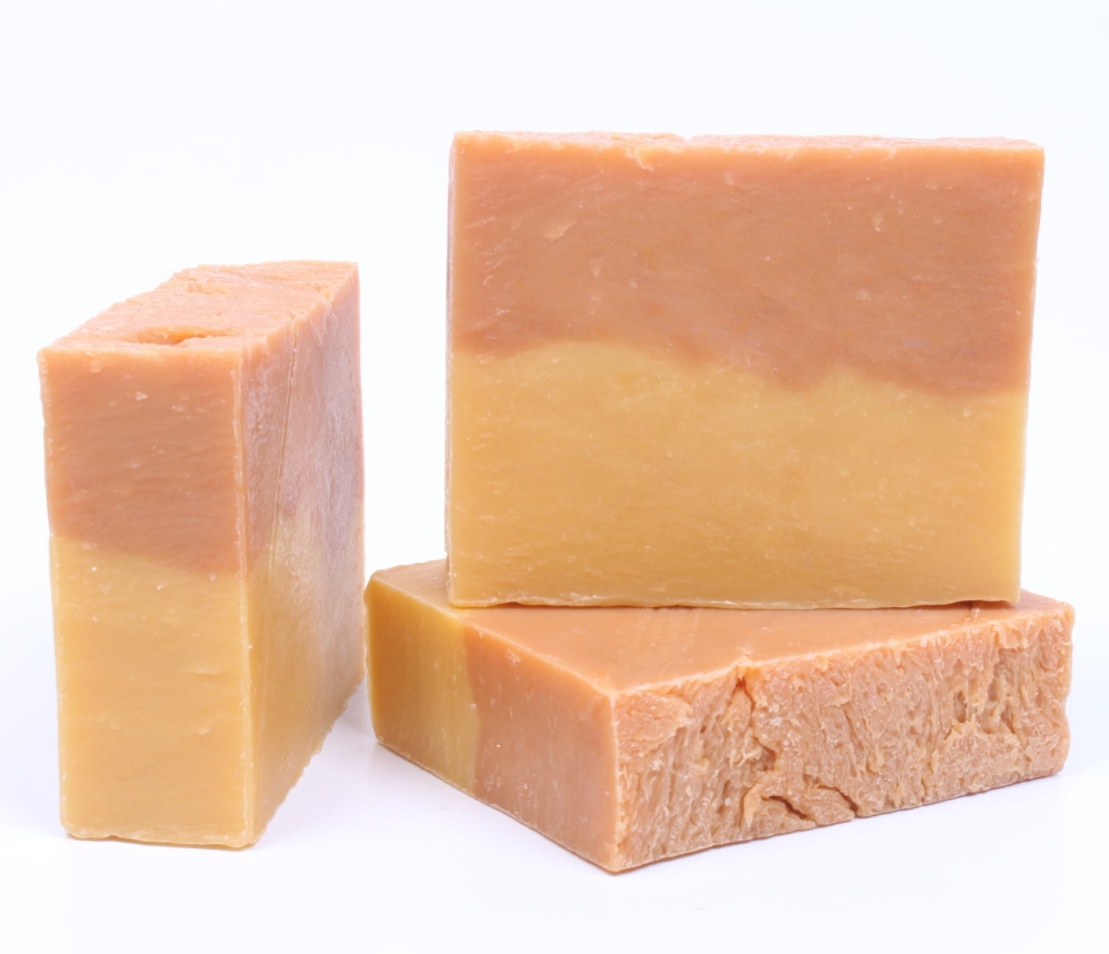 Three bars of soap with a gradient color pattern on a white background