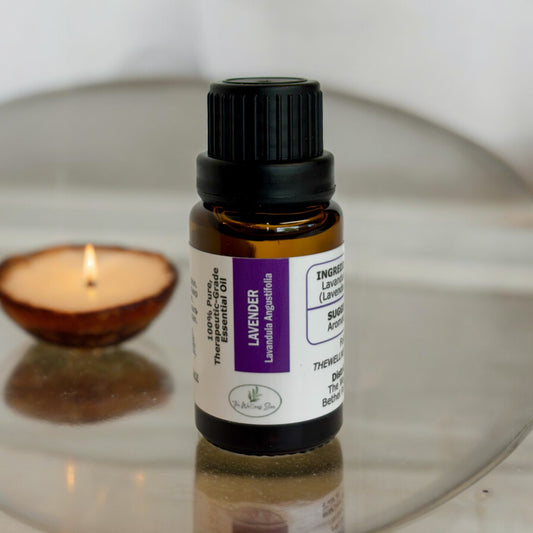 Lavender Essential oil on a round surface with a lit candle faded into the background