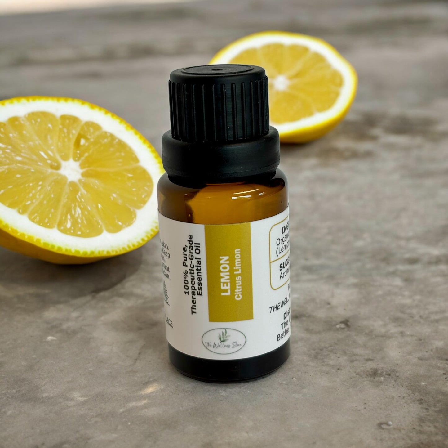 Lemon essential oil on a rough surface with lemons in the background