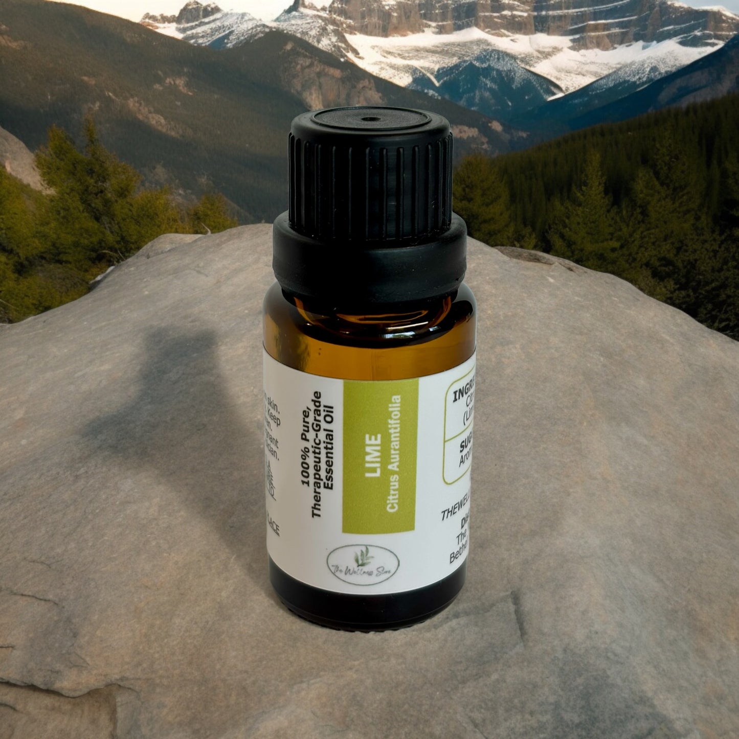 Lime essential oil on a rock overlooking a valley with mountains in the background
