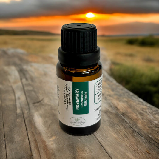 Therapeutic Grade Essential Oil on a wood  table with a sunset in the backround