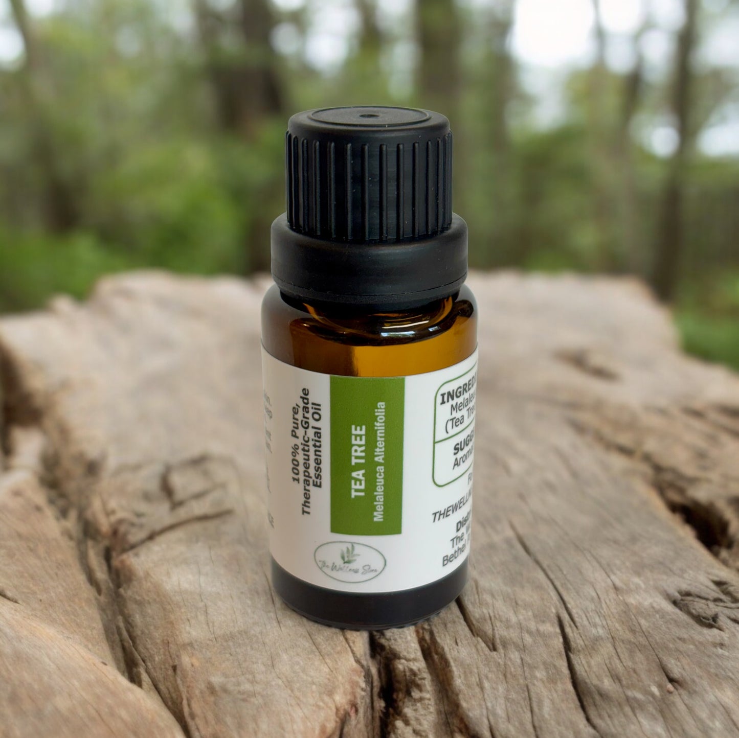 tea tree essential oil on a rough wood surface with woods blurred in the background