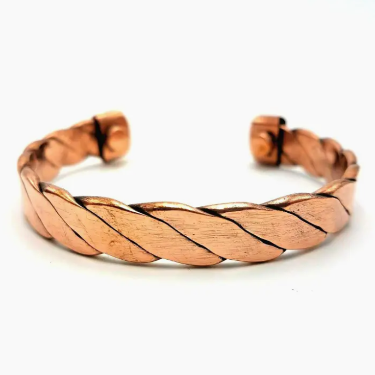 Copper braided bracelet on a white background