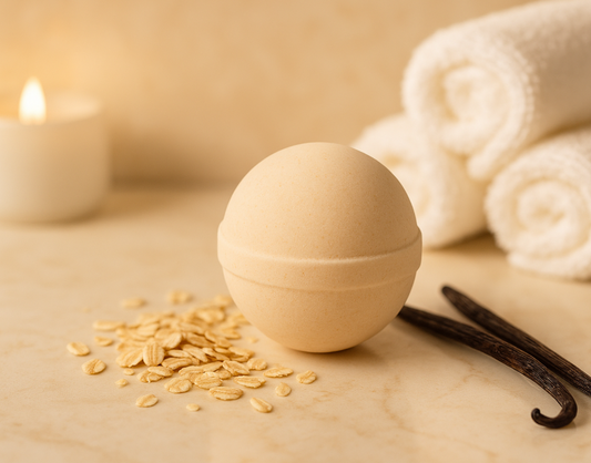 Bath bomb with oats, vanilla bean, and candles on a beige surface