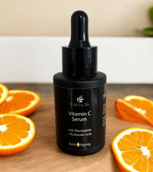 Black bottle of Vitamin C Serum with oranges on a wooden surface