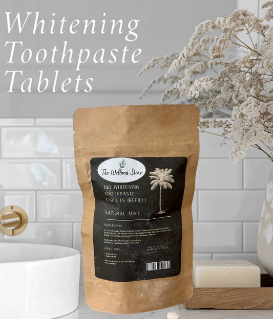 Package of Whitening Toothpaste Tablets with a black label on a bathroom counter.