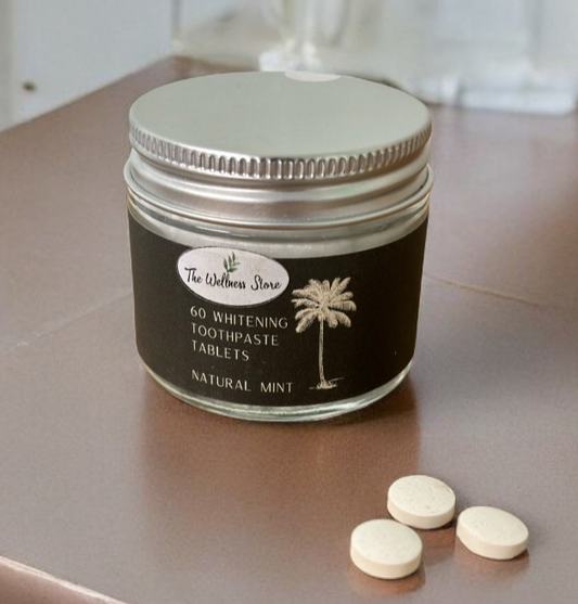 Jar of 60 whitening toothpaste tablets with palm tree design on a countertop.