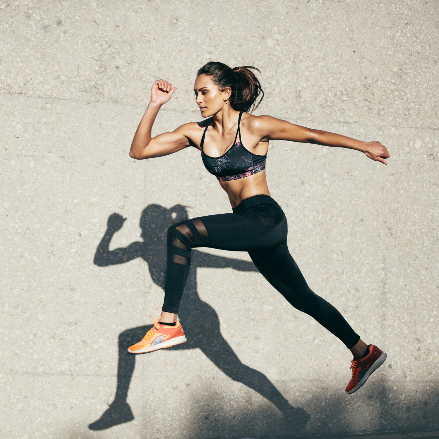 Energy supplement lifestyle: active woman running outdoors showing natural vitality and endurance