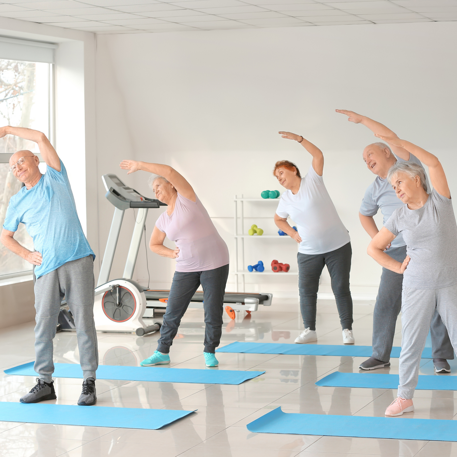Older people working out in a gym to maintain healthy aging