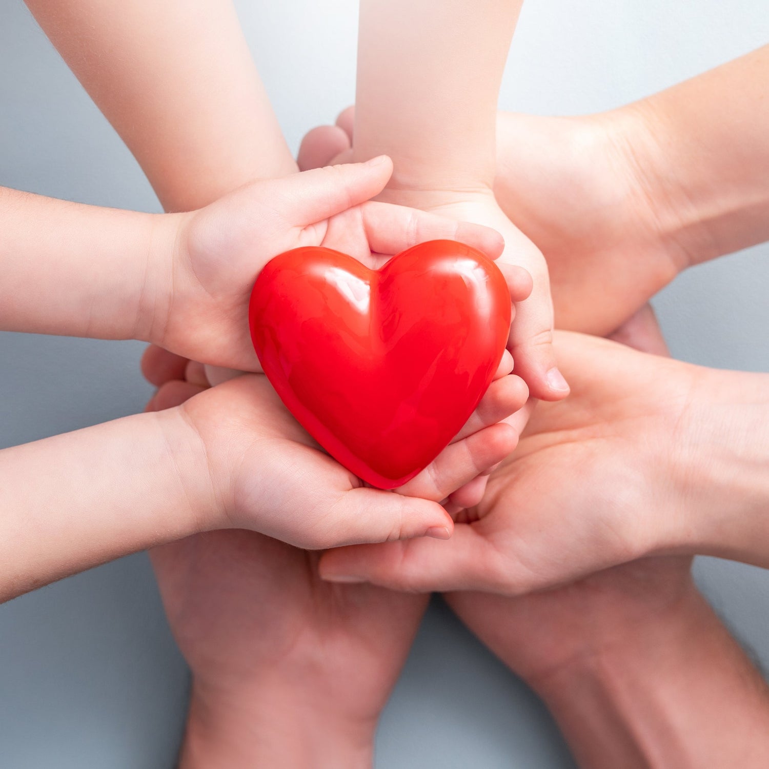 3 sets of stacked hands holding a heart