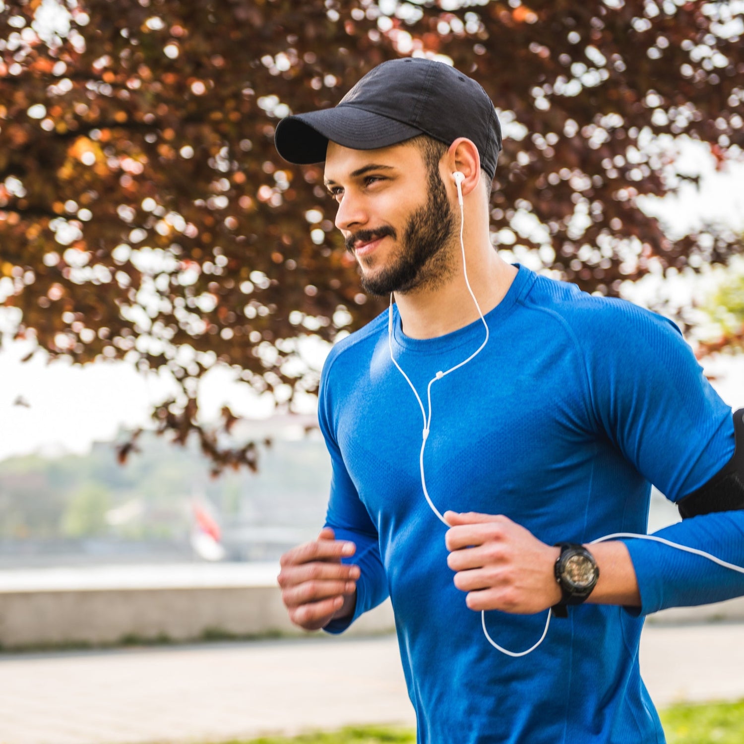 Man jogging down the road listening to music