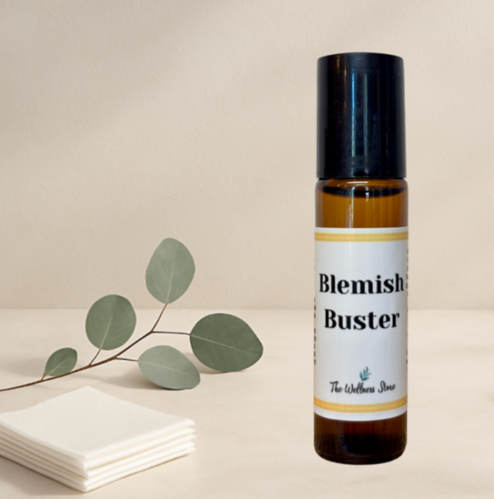 Bottle of 'Blemish Buster' with a leaf branch on a beige background