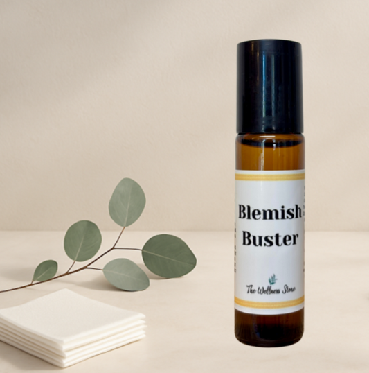 Bottle of 'Blemish Buster' with a leaf branch on a beige background