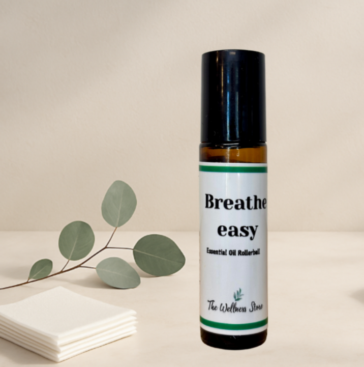 Roll-on bottle labeled 'Breathe easy' with a branch of eucalyptus leaves on a neutral background