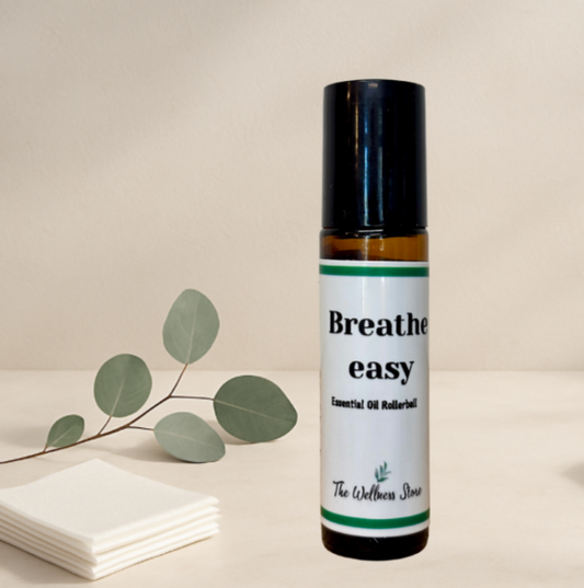 Roll-on bottle labeled 'Breathe easy' with a branch of eucalyptus leaves on a neutral background
