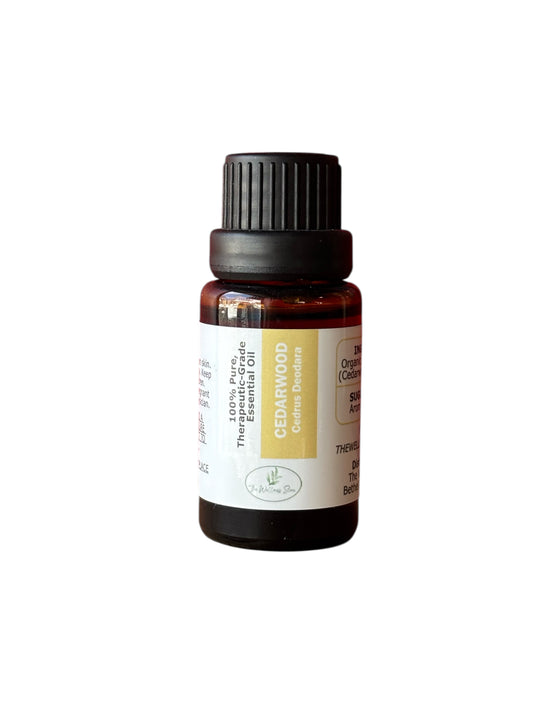 Cedarwood therapeutic‑grade essential oil bottle from The Wellness Store on a white background
