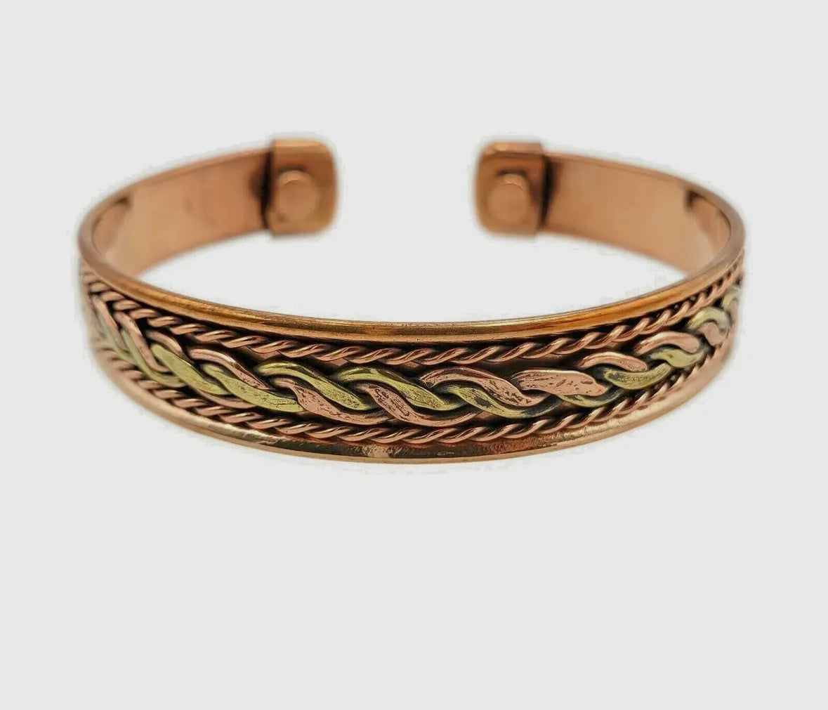 Bronze bracelet with intricate design on a white background