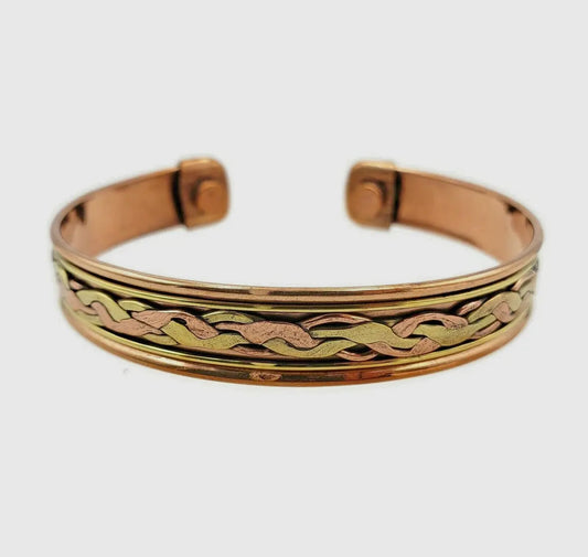 Gold and rose gold bangle with braided design on a white background