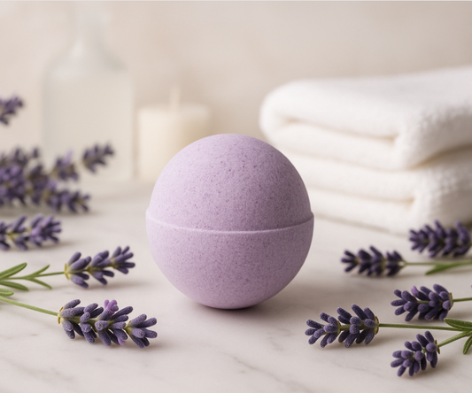 Purple bath bomb with lavender flowers on a light surface
