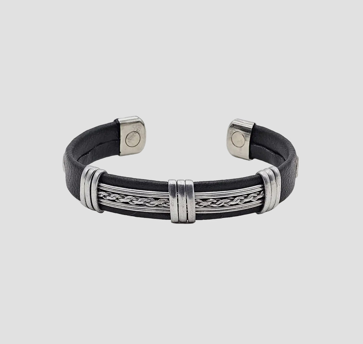 Black leather bracelet with silver metal accents on a light gray background