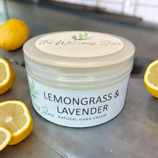 Lemongrass Lavender natural hand cream on a table with cut lemons around it
