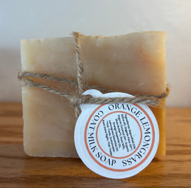 Bar of soap with a label on a wooden surface