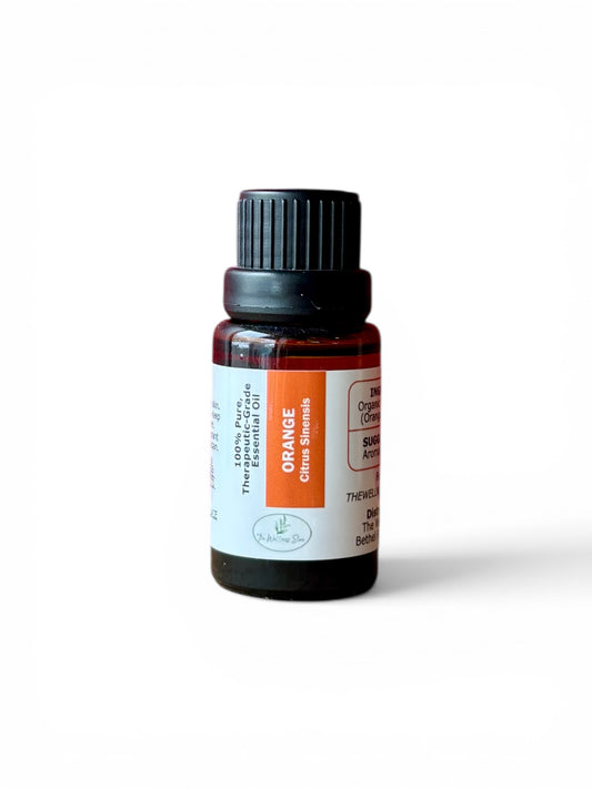 Orange therapeutic‑grade essential oil bottle from The Wellness Store on a white background