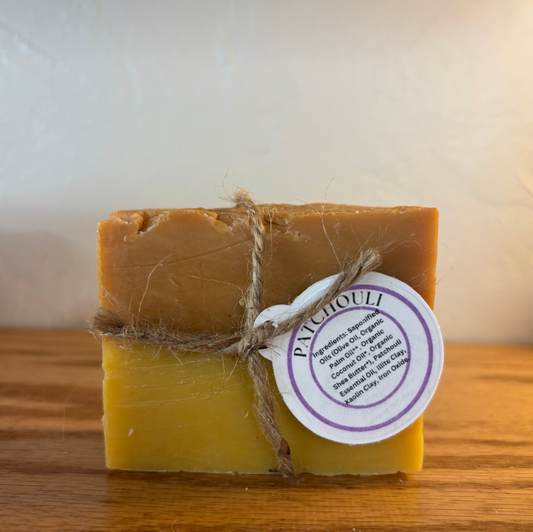 Bar of soap with a label on a wooden surface
