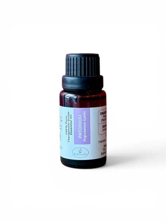 Patchouli therapeutic‑grade essential oil bottle from The Wellness Store on a white background