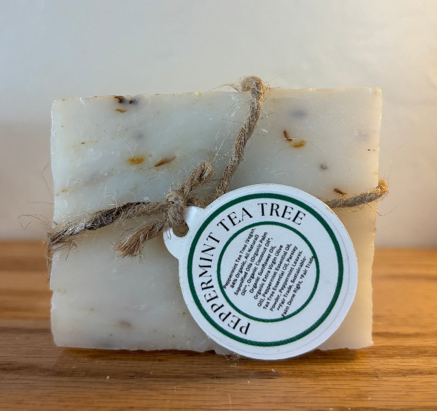 Bar of soap with a label on a wooden surface