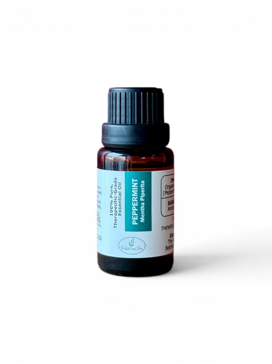 Peppermint therapeutic‑grade essential oil bottle from The Wellness Store on a white background