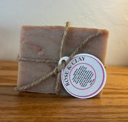 Bar of soap with a 'Rose & Clay' label on a wooden surface