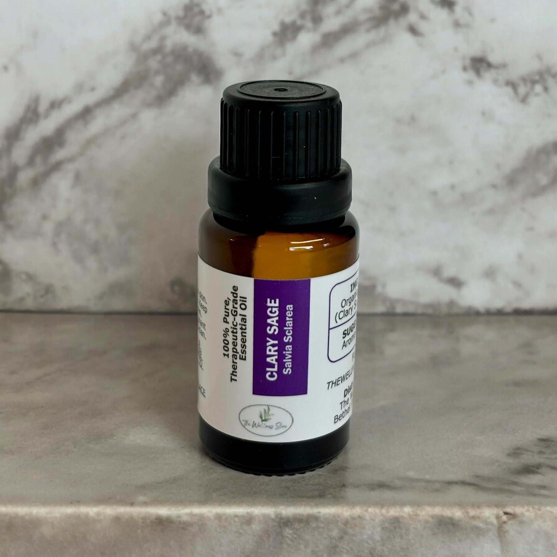 Clary Sage oil from the wellness store on a marble shelf with a marble background
