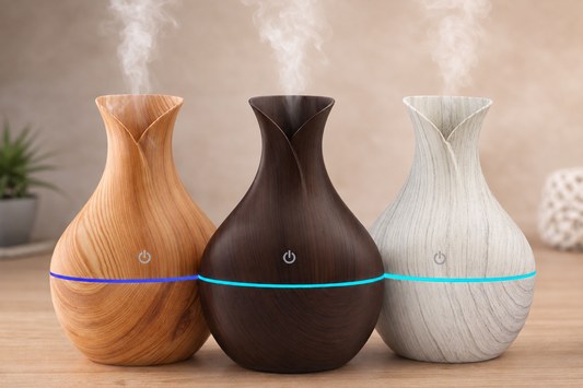 Petal-shaped ultrasonic aroma diffusers in light wood, dark wood, and marble finishes, releasing a soft mist