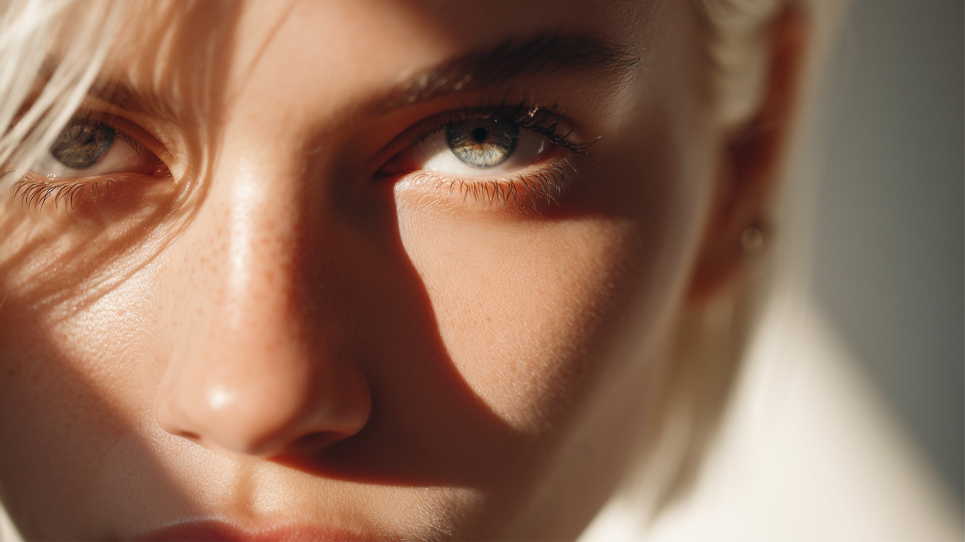 Close-up of a person's face with sunlight casting shadows
